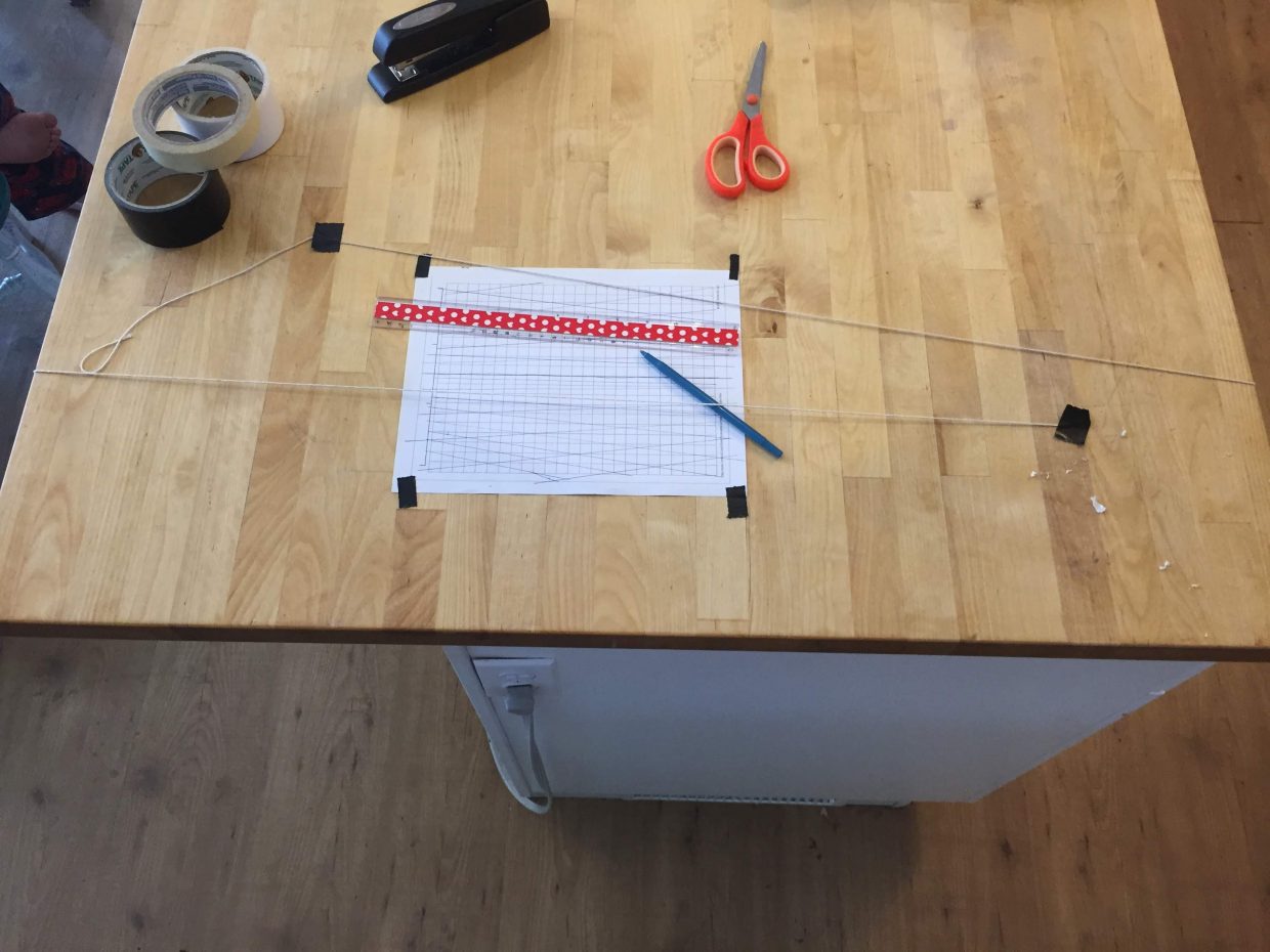 strings crossing over paper establishing 2 point perspective