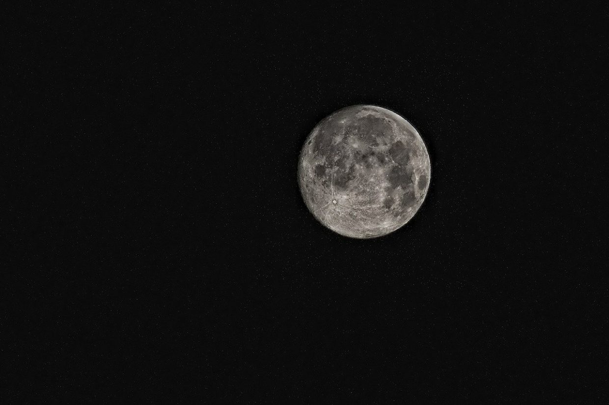 Dim moon on a dark sky