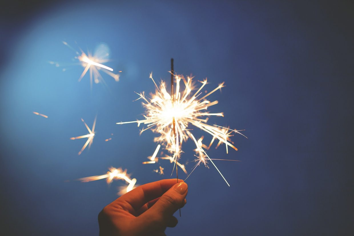 A lit sparkler in the night