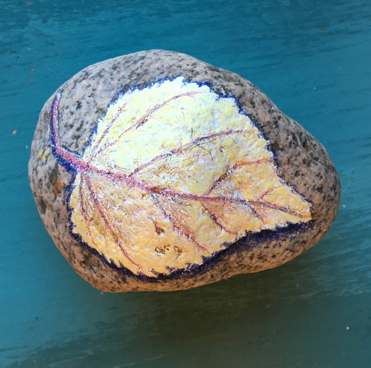 Pencil crayon leaf on a rock
