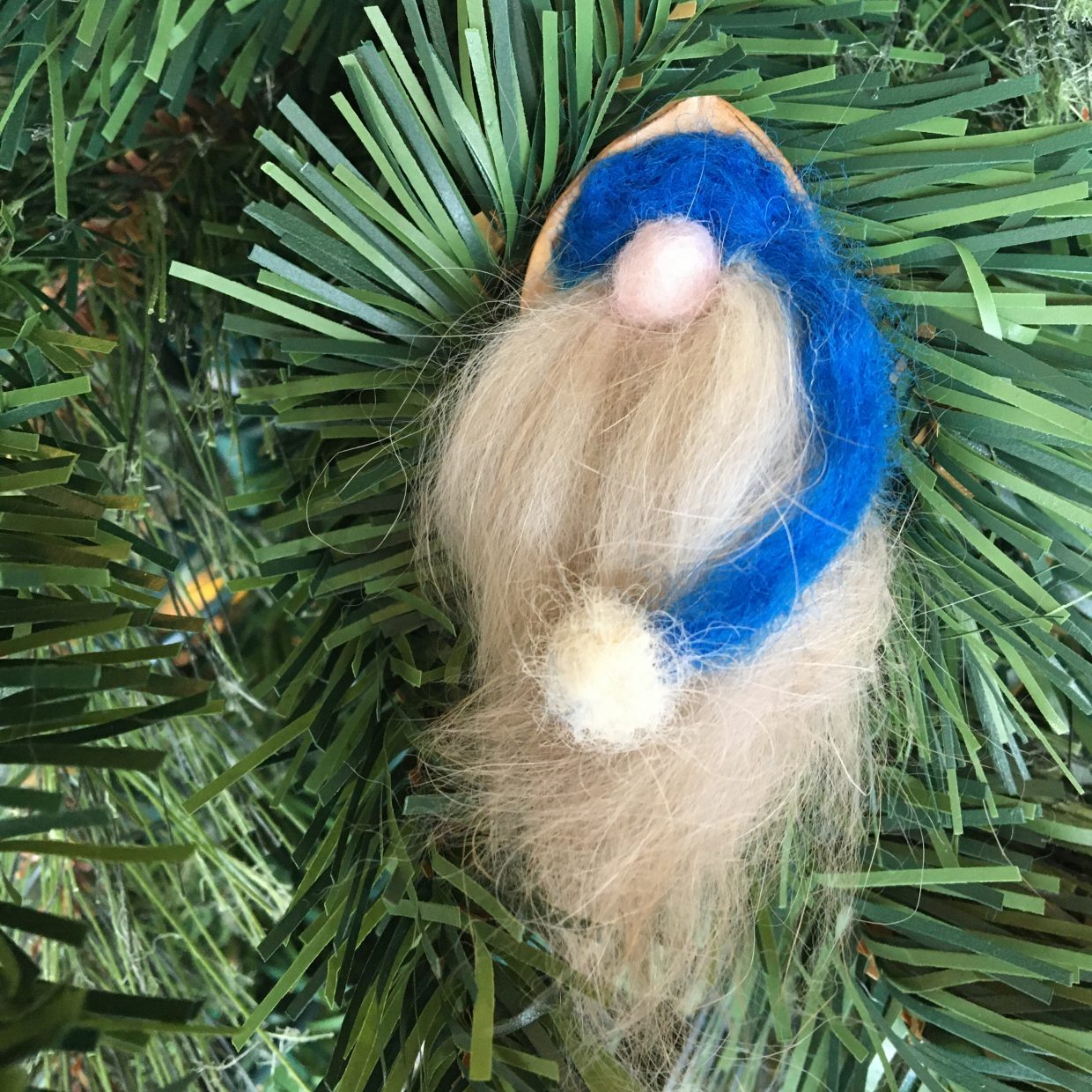 blue felted gnome in walnut shell